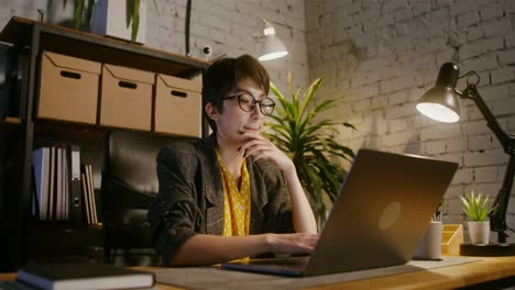 woman working late at home office on laptop