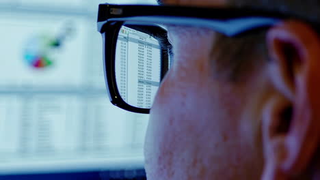 person looking at computer screen with financial data.