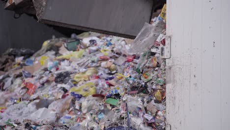 Close-up-of-waste-truck-unloading,-managing-and-disposing-of-waste-materials