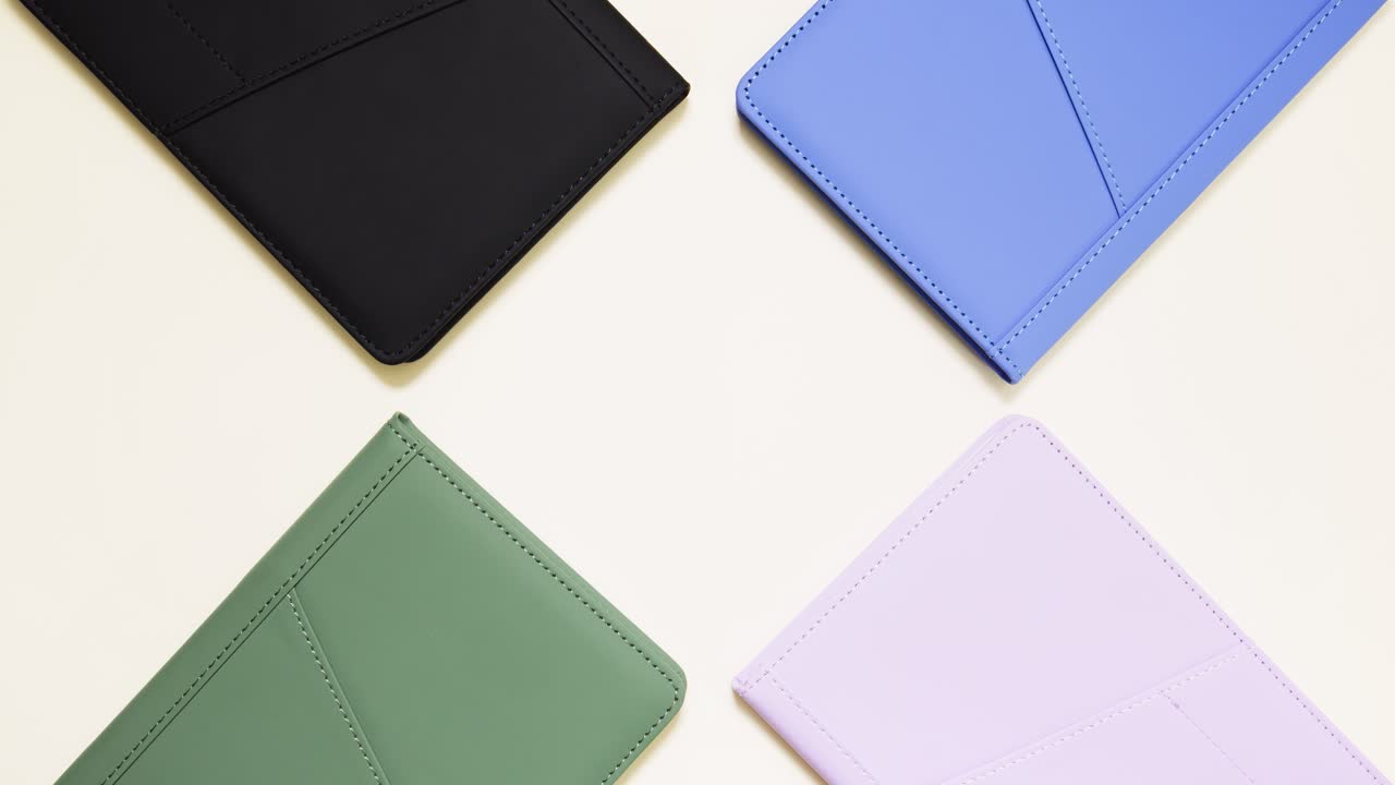 Stop motion of colorful notebooks circling, center copy space on light backdrop