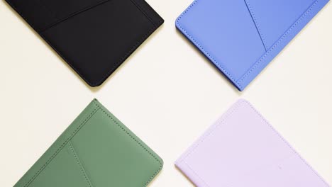 stop motion of colorful notebooks circling, center copy space on light backdrop