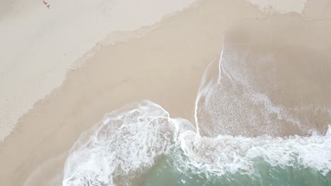 aerial view or seen from above of the waves and white sand on klayar beach, pacitan, indonesia