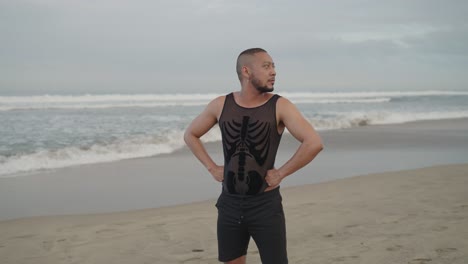 man on beach in unique outfit