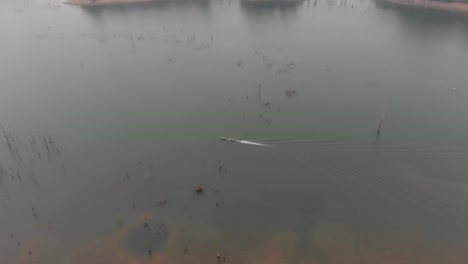 Drone-view-of-the-Nam-Theun-River-at-Laos-with-a-small-boat,-aerial