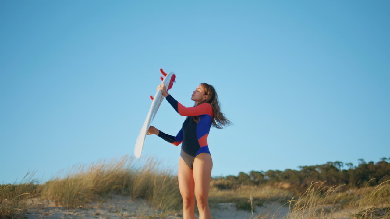 Confident surfer walking nature at summer. Sexy surf girl waiting waves at beach