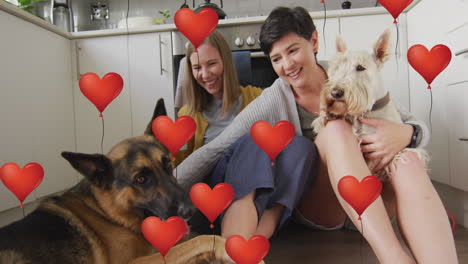 animación de iconos de globos de corazón rojo sobre una pareja de mujeres con perros mascotas.