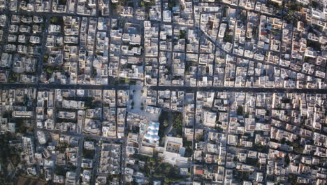 Wide-top-down-aerial-timelapse-of-the-traffic-and-pedestrian-movement-in-the-daytime-of-the-Italian-town-of-Prezze-di-Greco,-Italy