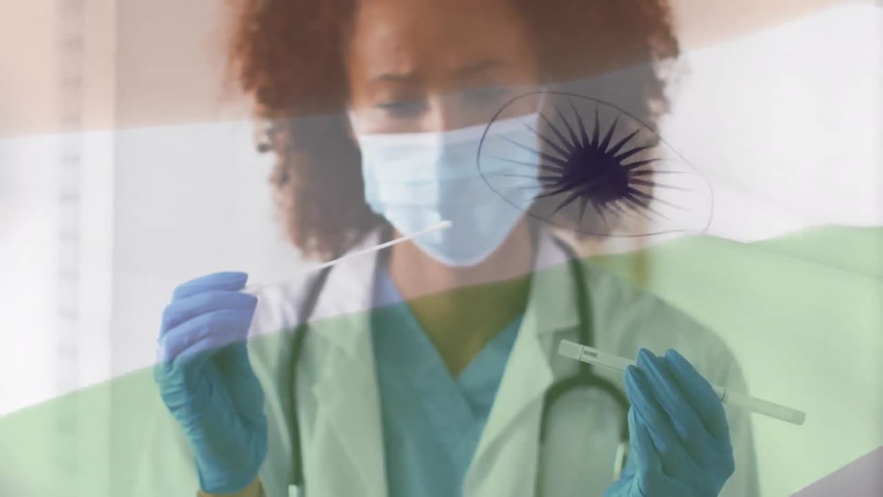 Animation of flag of india over female doctor in face mask and gloves inspecting covid test swab