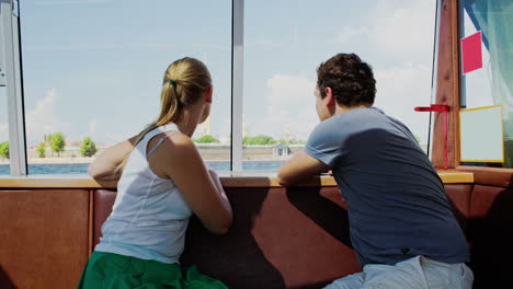 young couple traveling by touristic boat