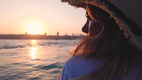 Slow-Motion:Beautiful-girl-enjoys-sunset-view-of-bosphorus-and-Istanbul,-a-popular-destination-in-Istanbul,-Turkey