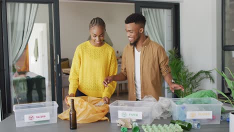 happy african american couple recycling waste