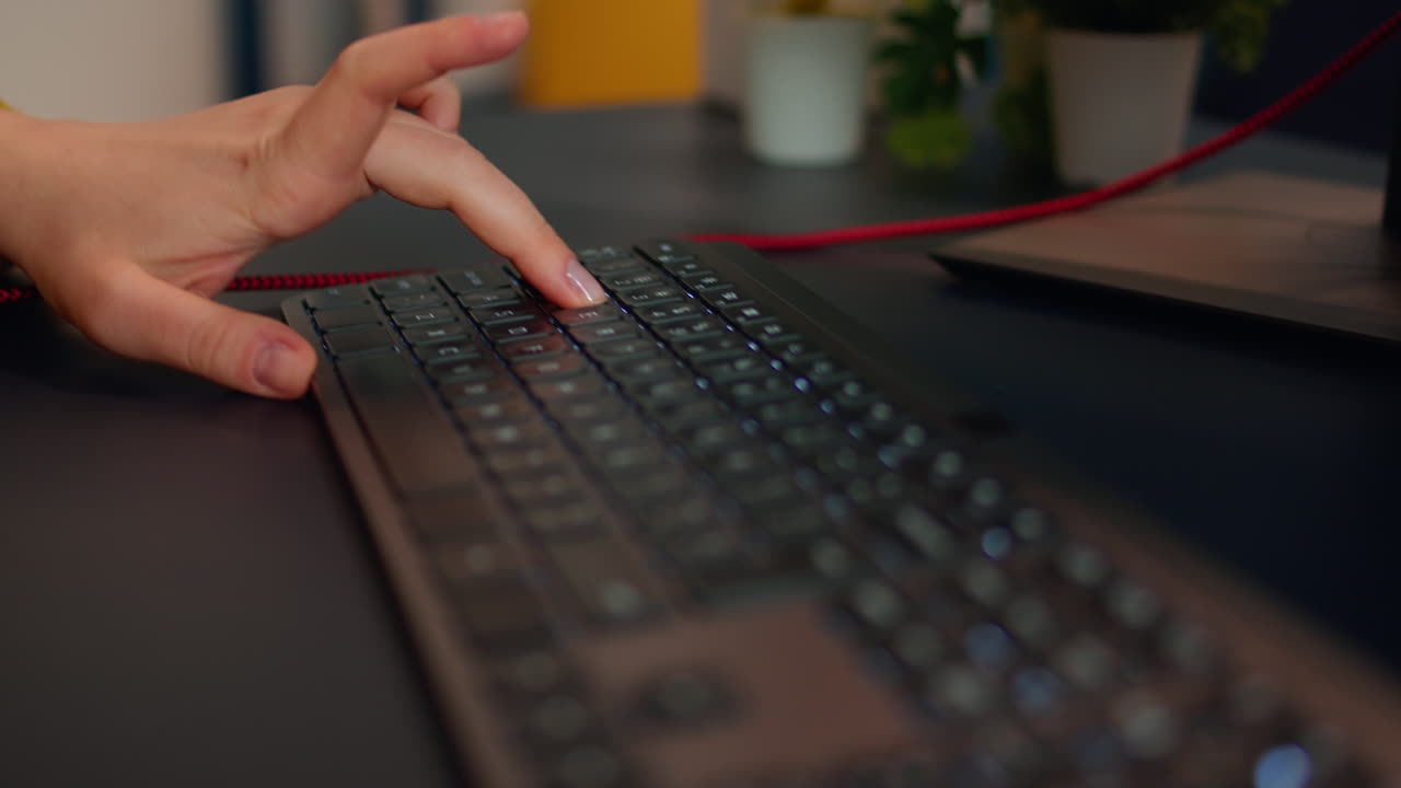 Close-up on hands of woman gamer playing video game