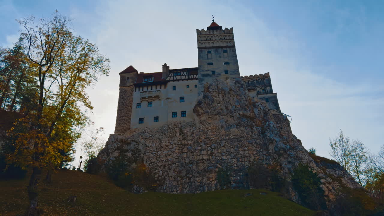 Beautiful castle Bran the concealment on vicious Count Dracula. Low angle view of the historic building in autumn nature.