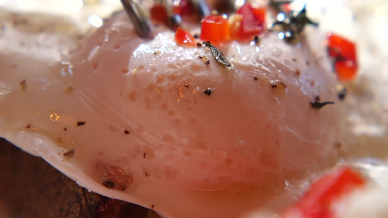 Close-up of a Poached Egg with Creamy Sauce and Spices