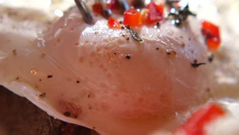 close-up of a poached egg with creamy sauce and spices
