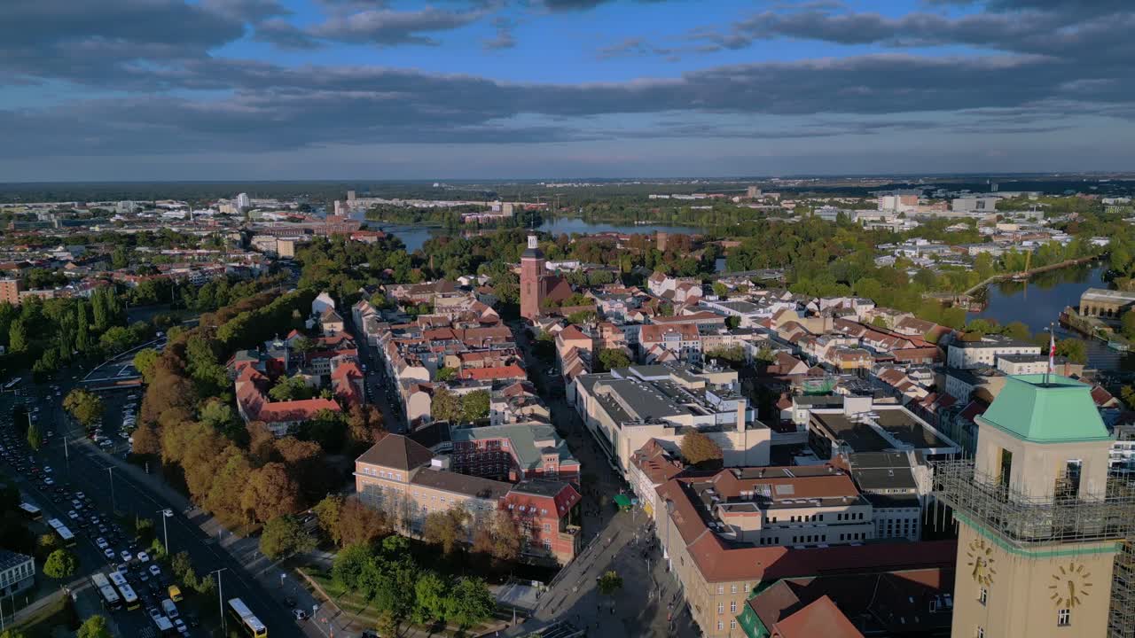 Berlin Spandau old town with its red rooftops, churches, and surrounding greenery. Magic aerial view flight descending drone