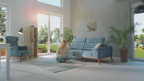 woman using laptop sitting on floor