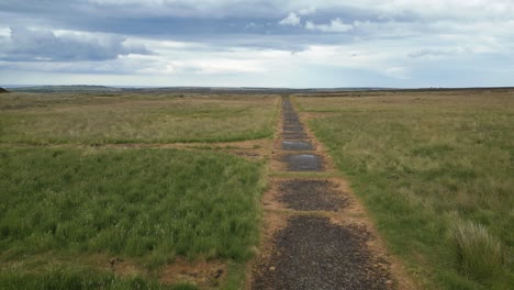 remains of raf danby beacon, a listening station from wwii - low level aerial shot following access road