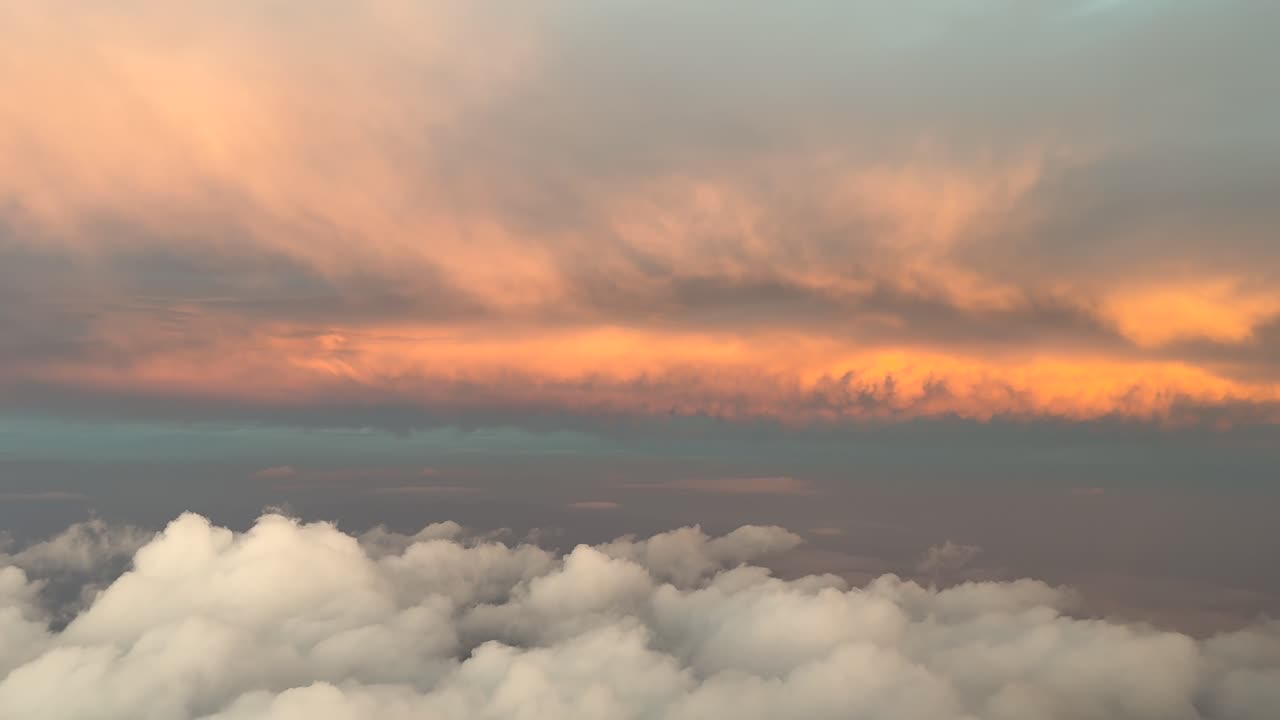 Immersive pilot’s perspective flying through an early morning sky with some golden color clouds ahead. Aerial shot taken from a jet cockpit as seen by the pilots. 4K 60FPS