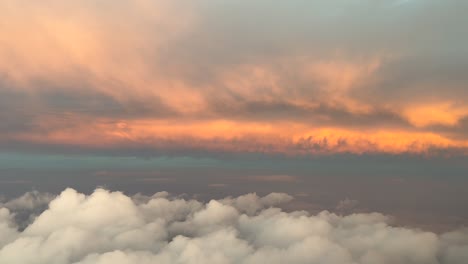 immersive pilot’s perspective flying through an early morning sky with some golden color clouds ahead. aerial shot taken from a jet cockpit as seen by the pilots. 4k 60fps