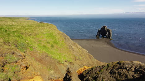 hvitserkur 15 meter high basalt stack in iceland, zoom out view