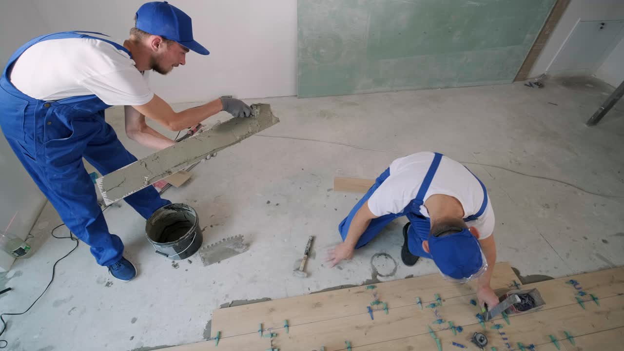 Construction, renovation, repair apartment. Installing ceramic floor tiles - measuring and cutting the pieces. Cuts tile. Tile cutting