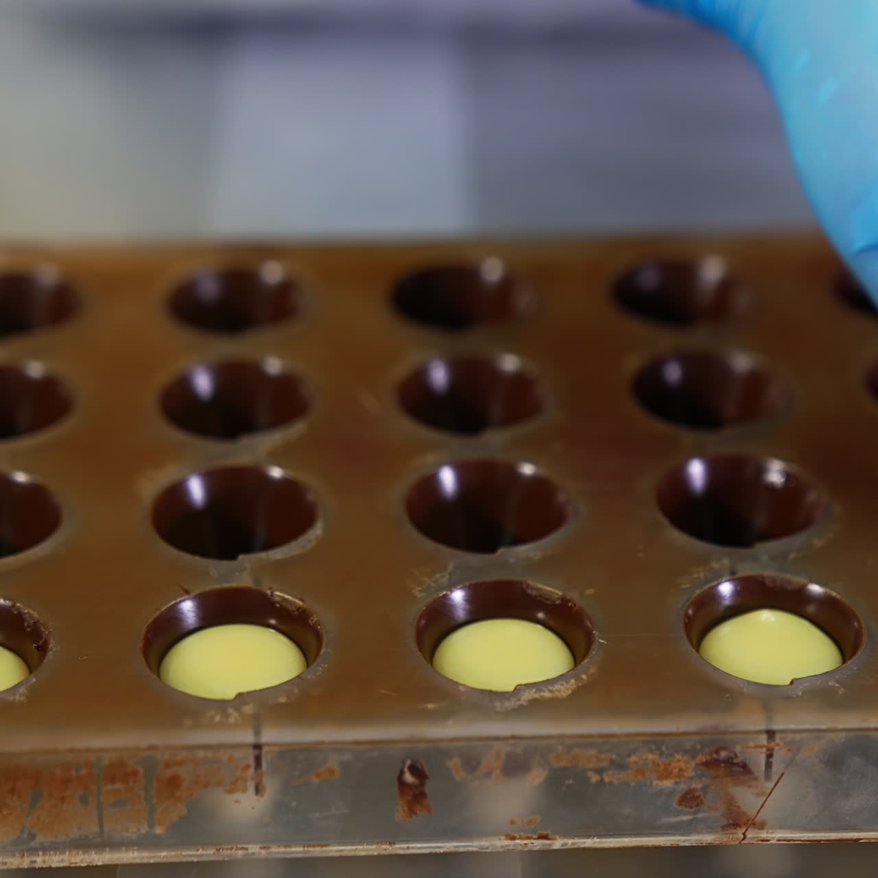 Making chocolates with piping bag