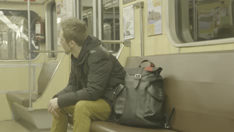 man sitting on a subway train