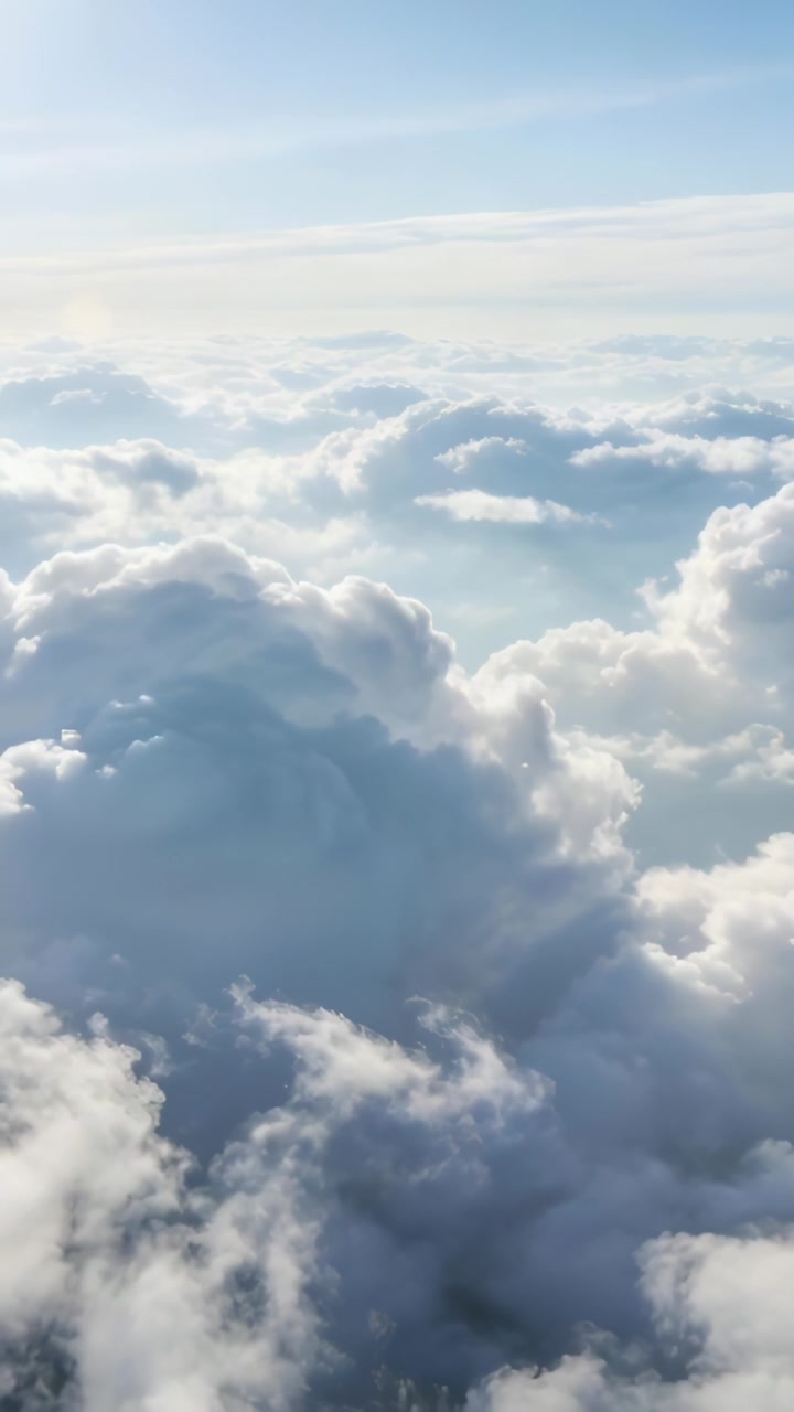 Vertical video: Gliding drone starting forward over cumulus mass, showing wisps and cloud structure