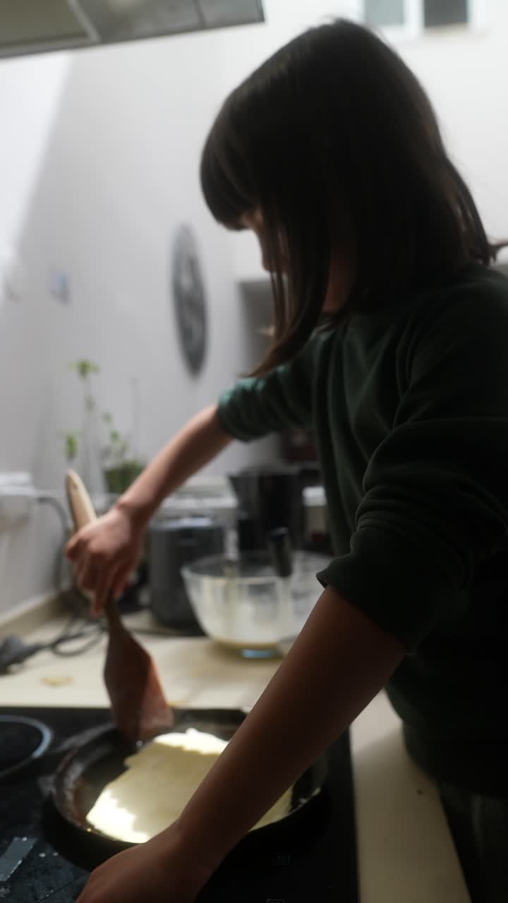 A girl cooking pancakes