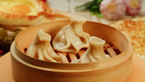 steamed khinkali in a bamboo steamer