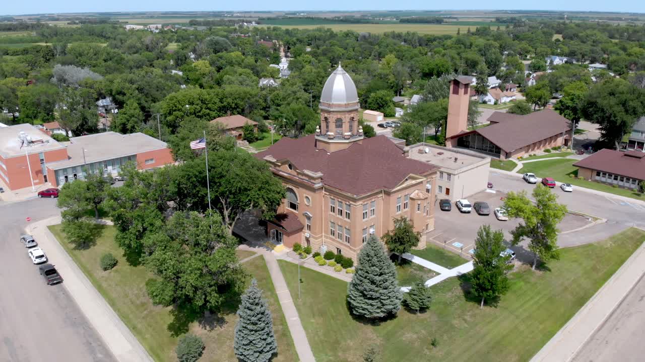 Drone wide orbit shot around historic courthouse.