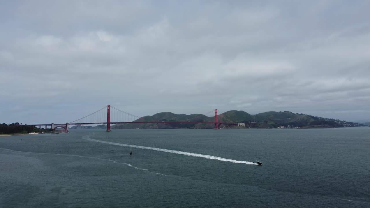 Speed Boat Leaving A Long Wake Trail Under The Famous Golden Gate Bridge In San Francisco Bay, California, USA.