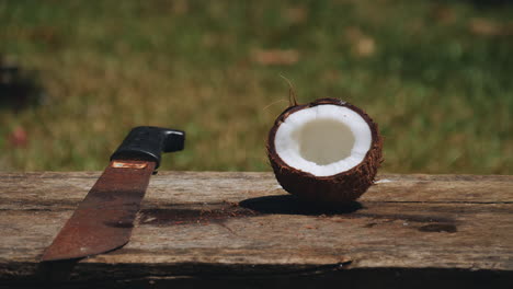 Una-Cáscara-De-Coco-En-Un-Banco-Con-Un-Machete-Que-Lo-Partió-Por-La-Mitad