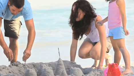 Beautiful-mother-building-a-sand-castle-with-her-daughter