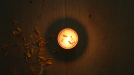 flower petals being throw around a diya or a tradition lamp used for various hindu festive celebrations for the festival of light- diwali and also for others like dussehra or prayers at home or temple