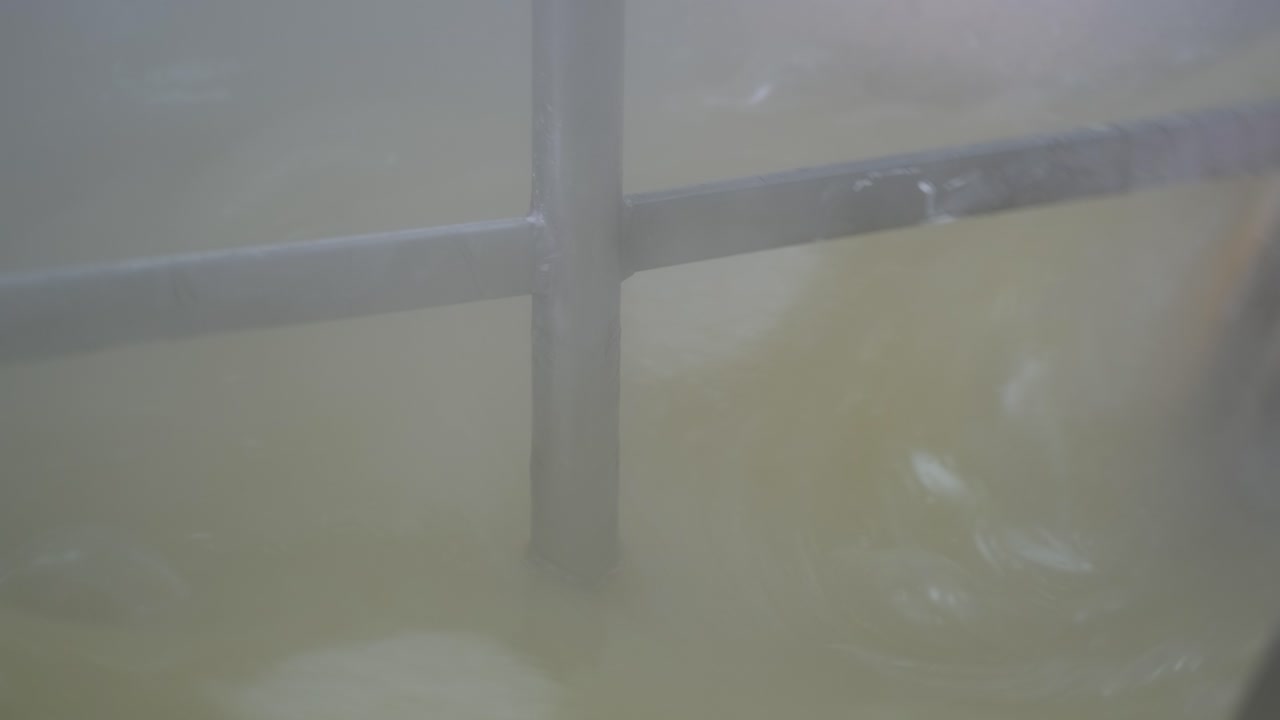 primer plano extremo del brazo mezclador dentro de una caldera industrial mientras se preparan delicias turcas