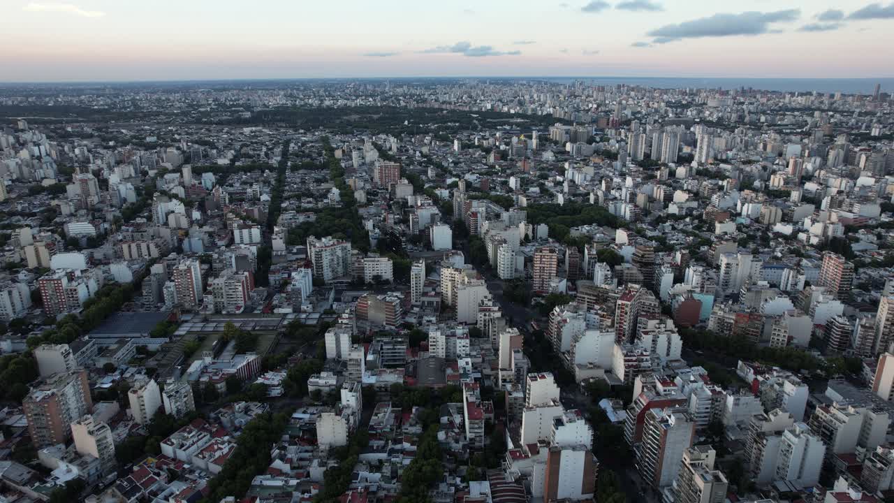 side tracking shot with drone in the Argentine capital, many buildings, soft sunset light