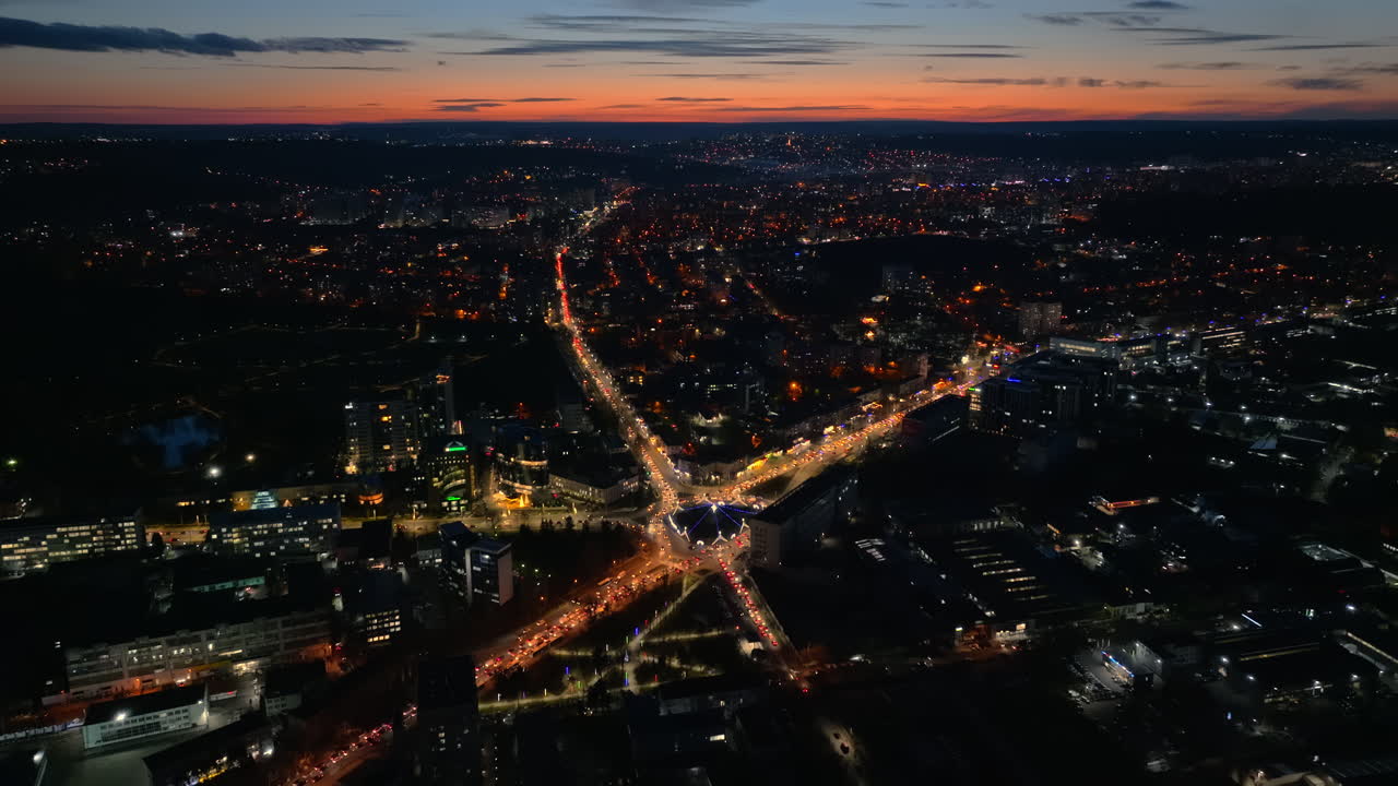 Aerial drone view of cars in traffic at a roundabout in Chisinau, Moldova at sunset