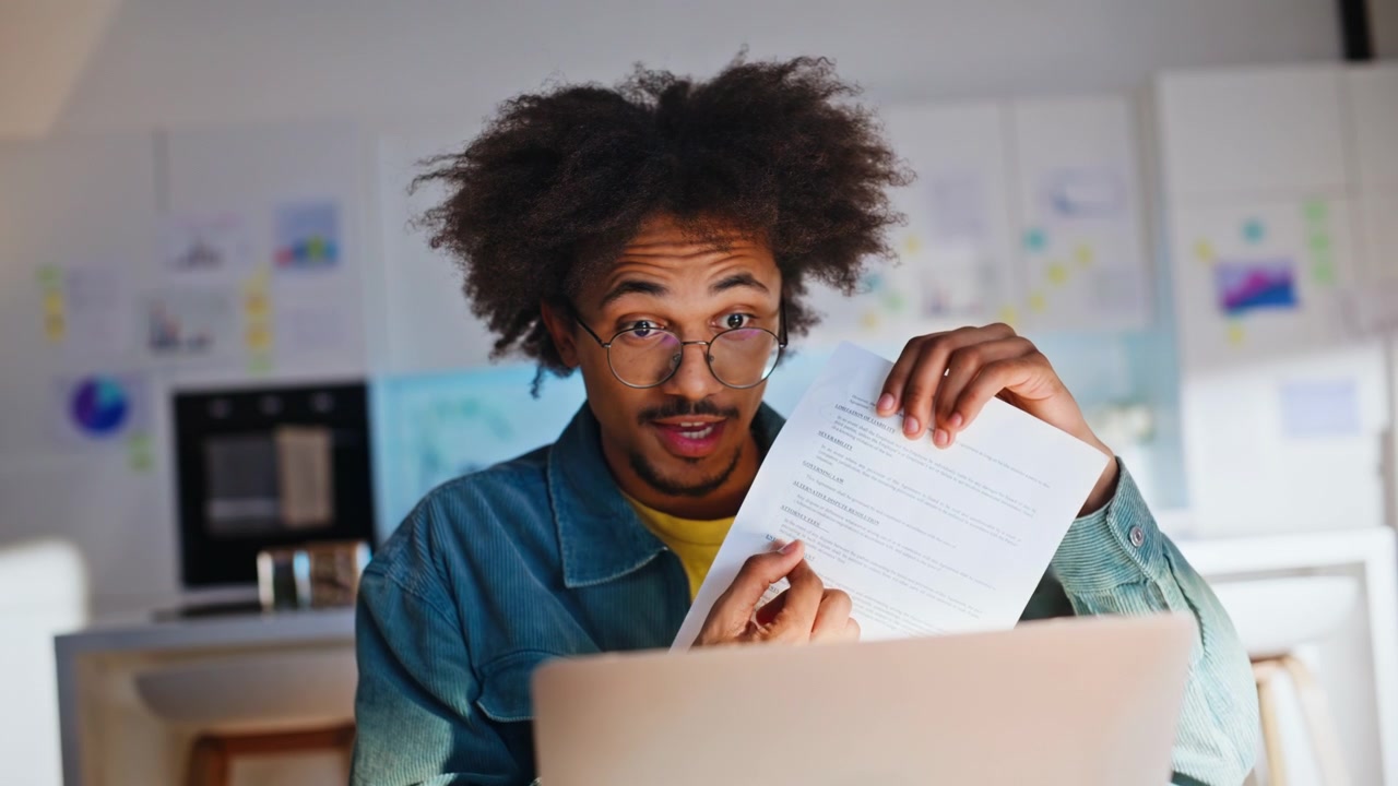 Man showing document laptop video call. Close up happy freelancer home kitchen.