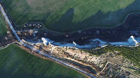 aerial view of a rural landscape with a cliff formation