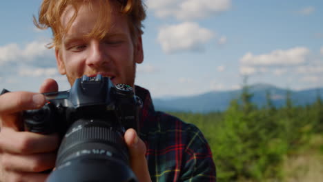 Male-photographer-taking-photos-of-the-mountains-during-hike