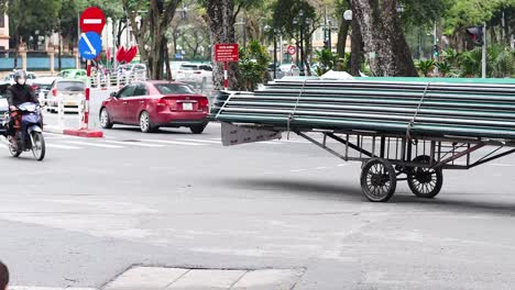 motorbikes and cars navigate a bustling intersection