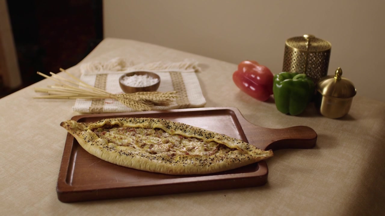 Delicious traditional Turkish pide, a boat-shaped flatbread with toppings, on a restaurant table