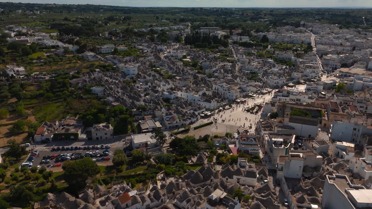 Historic Trulli houses area, Alberobello, Apulia, Italy. Tourists visible in the iconic old town.