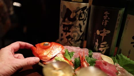 hands arranging a sushi platter delicately