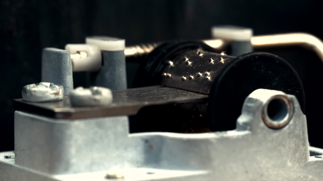Detailed view of the insides of an old vintage music box as it plays. Slow tracking movements