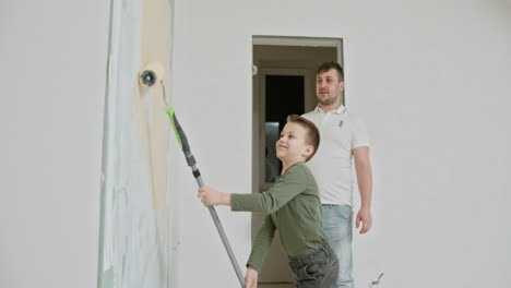 father and son painting a wall