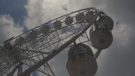 ferris wheel rotating in the clouds, carnival amusement park in 4k