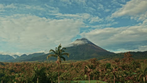 aerial drone shot of the arenal volcano in costa rica. high view of the tropical rainforest. lush landscape home to biodiversity and thermal springs.